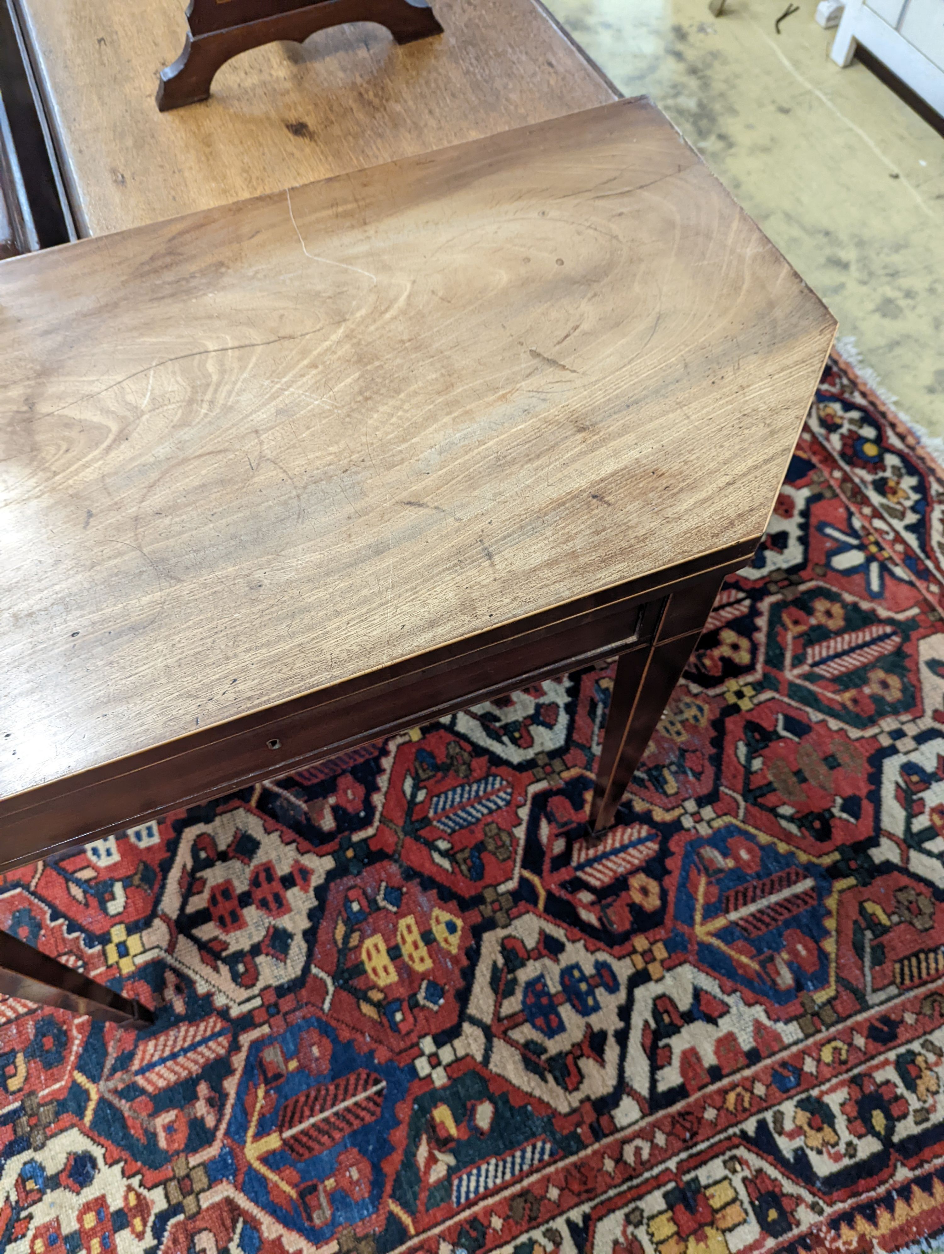 A George III faded mahogany folding tea table, width 97cm, depth 47cm, height 75cm